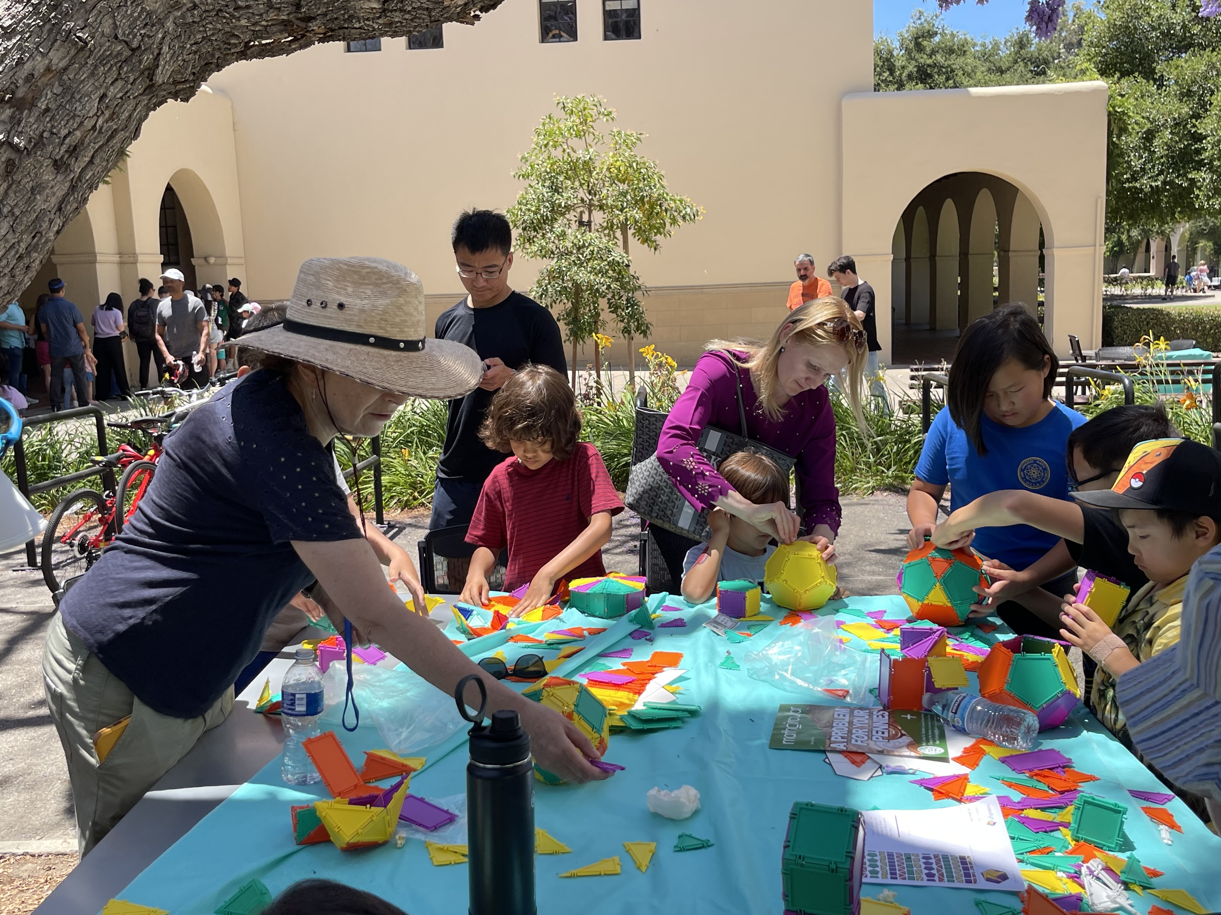 People playing with tiles from AIMs Math Fair